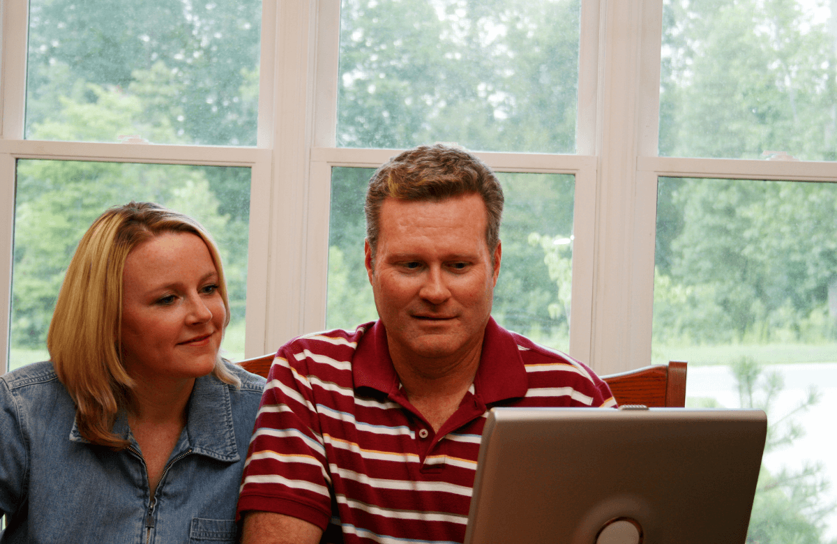 A couple applying for payday loans in Cambridge from home